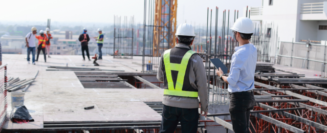 Two property owners reviewing project progress for surety bond filing