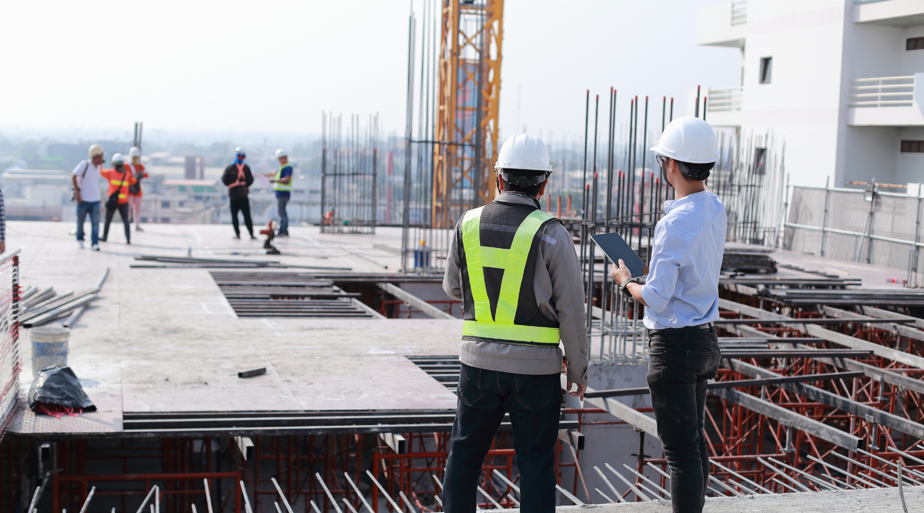 Two property owners reviewing project progress for surety bond filing